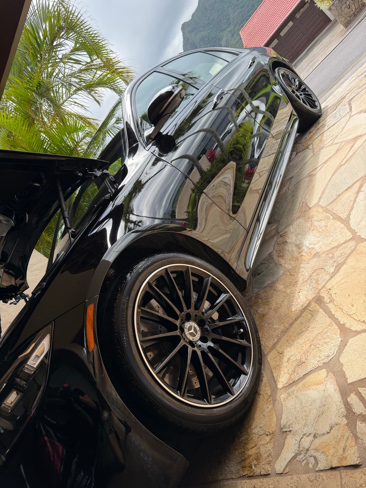 Freshly detailed black Mercedes-Benz with polished wheels in a Hawaii Kai driveway — Oahu, Hawaii